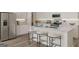 Light and bright kitchen features stainless appliances, ample counter space, and island bar seating at 505 Altamaha Court, Locust Grove, GA 30248