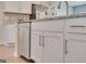 Bright and modern kitchen showcasing stainless steel appliances, granite counters, and island bar seating at 505 Altamaha Court, Locust Grove, GA 30248
