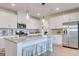 Bright open kitchen showcasing stainless steel appliances, granite counters, island bar, and white cabinets at 505 Altamaha Court, Locust Grove, GA 30248