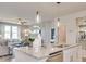 Open concept kitchen with island bar seating, stainless appliances, and decorative pendant lighting at 505 Altamaha Court, Locust Grove, GA 30248