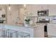 A modern kitchen features a gray granite island, stainless appliances, and white cabinetry at 505 Altamaha Court, Locust Grove, GA 30248