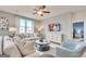 Comfortable living room features a ceiling fan, modern furniture, and an open layout at 505 Altamaha Court, Locust Grove, GA 30248