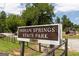 Indian Springs State Park sign surrounded by lush greenery and trees on a sunny day at 505 Altamaha Court, Locust Grove, GA 30248
