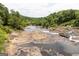 Scenic river view featuring rocks and trees along the riverbanks in a natural setting at 505 Altamaha Court, Locust Grove, GA 30248