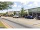 Street view of local shops featuring ample parking and sidewalk access at 505 Altamaha Court, Locust Grove, GA 30248