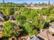 An elevated view of residences surrounded by lush green trees with the city skyline in the background at 1442 Valley Glen Way, Dunwoody, GA 30338