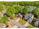 An elevated shot showcasing a neighborhood with mature trees and well-maintained homes on a sunny day at 1442 Valley Glen Way, Dunwoody, GA 30338