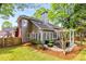 This backyard features a pergola covered patio, green lawn, and mature trees for outdoor enjoyment at 1442 Valley Glen Way, Dunwoody, GA 30338