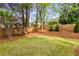Spacious backyard with green lawn, privacy fence, and mature trees provides ample space for outdoor activities at 1442 Valley Glen Way, Dunwoody, GA 30338
