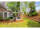Enjoy the green backyard from the covered patio, complete with comfortable seating and lush landscaping at 1442 Valley Glen Way, Dunwoody, GA 30338