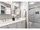 Bathroom with double sinks, large mirrors, and shower with a glass door at 1442 Valley Glen Way, Dunwoody, GA 30338