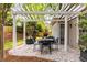 Entertain in style on the covered stone patio, complete with outdoor dining furniture and a grill at 1442 Valley Glen Way, Dunwoody, GA 30338