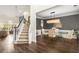 Elegant dining room featuring wood floors, staircase, decorative lighting, and a glass-top table with seating at 1442 Valley Glen Way, Dunwoody, GA 30338