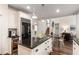 Open concept kitchen featuring dark countertops, white cabinets, an island, and stainless steel appliances at 1442 Valley Glen Way, Dunwoody, GA 30338