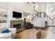 Bright living room with a fireplace, hardwood floors, staircase, and tall ceilings at 1442 Valley Glen Way, Dunwoody, GA 30338