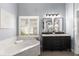 Main bathroom with double vanity, bathtub, and glass shower at 1442 Valley Glen Way, Dunwoody, GA 30338