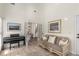 Bright sitting area features a piano, couch, and French doors at 1442 Valley Glen Way, Dunwoody, GA 30338