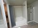 Well-lit bathroom featuring a bathtub and separate shower at 2162 Oakland Grove Pl, Lawrenceville, GA 30044