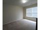 Bedroom with large window for natural lighting and neutral carpet at 2162 Oakland Grove Pl, Lawrenceville, GA 30044