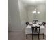 Dining room with a white table set for four under a modern chandelier at 2162 Oakland Grove Pl, Lawrenceville, GA 30044