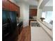 Kitchen with dark cabinets, stainless steel sink, and black appliances at 2162 Oakland Grove Pl, Lawrenceville, GA 30044