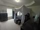 Spacious main bedroom featuring a canopy bed and natural light at 2162 Oakland Grove Pl, Lawrenceville, GA 30044