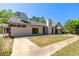 Backyard view of a home showing an expansive yard and a stylish exterior with modern windows and a tall chimney at 2320 Copper Trail Ln, Buford, GA 30519