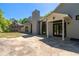 Exterior home featuring a large backyard patio and a two-story structure against a treed backdrop at 2320 Copper Trail Ln, Buford, GA 30519