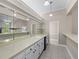 Updated bar area with a sink, storage cabinets, mirrored wall, tile flooring, and hanging pendant lighting at 2320 Copper Trail Ln, Buford, GA 30519