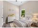 Cozy bedroom showcasing a metal bed frame, soft gray bedding, and natural light with a view of greenery outside at 2320 Copper Trail Ln, Buford, GA 30519