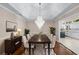 Elegant dining room featuring hardwood floors, a modern chandelier, and decorative accents at 2320 Copper Trail Ln, Buford, GA 30519