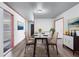 Bright dining room featuring a modern glass table, wood floors, and stylish decor against white walls at 2320 Copper Trail Ln, Buford, GA 30519