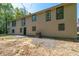 Side view of home featuring neutral siding, black trim windows, and black front door at 2320 Copper Trail Ln, Buford, GA 30519