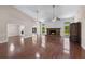 Spacious living room featuring hardwood floors, a fireplace, and natural light from large windows at 2320 Copper Trail Ln, Buford, GA 30519