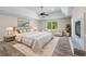 Main bedroom with a cozy sitting area, a decorative fireplace, and a serene view of the outdoors at 2320 Copper Trail Ln, Buford, GA 30519