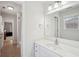 Bright bathroom boasts a large mirror, white vanity, and neutral walls with tile flooring at 553 Augusta Dr, Canton, GA 30115
