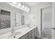Bright bathroom featuring a double vanity, neutral walls, and a view of the toilet and shower at 553 Augusta Dr, Canton, GA 30115