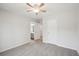 Bright bedroom featuring a ceiling fan, door, and a view of the hall and connected bathroom at 553 Augusta Dr, Canton, GA 30115