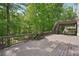 Expansive wooden deck with staircase and shaded area with views of lush trees and natural surroundings at 553 Augusta Dr, Canton, GA 30115