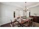 Formal dining room features a chandelier, wood floors, and classic wainscoting at 553 Augusta Dr, Canton, GA 30115