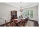 Formal dining room showcases elegant wainscoting, a chandelier, and natural light from shuttered windows at 553 Augusta Dr, Canton, GA 30115