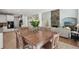 Bright dining area adjacent to living room has wood table, seating, and stone fireplace at 553 Augusta Dr, Canton, GA 30115