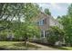 A beautiful brick home with lush green lawn, mature trees, and manicured shrubbery lining the front at 553 Augusta Dr, Canton, GA 30115