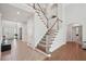 Inviting foyer with hardwood floors, staircase and view of the entry doors and the formal living area at 553 Augusta Dr, Canton, GA 30115