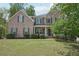 Charming brick home with a well-manicured lawn and mature landscaping, providing great curb appeal at 553 Augusta Dr, Canton, GA 30115