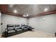 Carpeted home theater with a projector, screen, and comfortable seating at 553 Augusta Dr, Canton, GA 30115