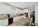 Bright kitchen features stone countertops, stainless appliances, and an island at 553 Augusta Dr, Canton, GA 30115