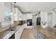 Bright kitchen features stone countertops, stainless appliances, and an island at 553 Augusta Dr, Canton, GA 30115