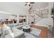 Spacious living room offering a view of the staircase, kitchen, dining, and a cozy stone fireplace at 553 Augusta Dr, Canton, GA 30115