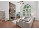 Bright living room boasts a soaring ceiling, large windows, hardwood floors, and stone fireplace at 553 Augusta Dr, Canton, GA 30115